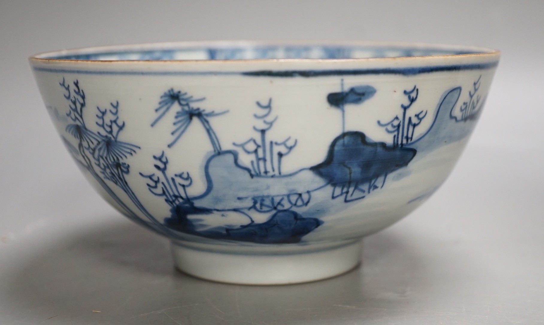 A Chinese Ming dynasty internally decorated porcelain tea bowl, an 18th century blue and white bowl, two other blue and white bowls, a similar water pot and an Islamic brass vessel